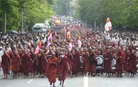 The Saffron Revolution 2007: Monks march for peace with the holy image of Buddha