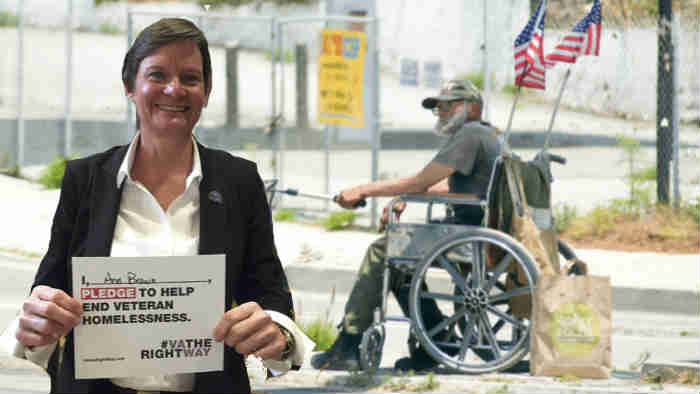 Ann Brown with sign pledging to help end Veteran homelessness