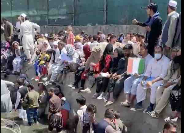 In Kabul: Knee deep in sewage, waving their papers, begging to be let in